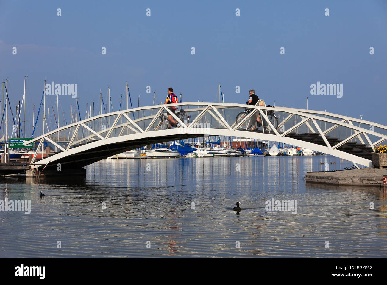Cyclists on a bridge, Rust marina, Lake Neusiedl, Burgenland, Austria, Europe Stock Photo