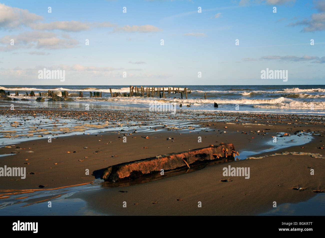 Old and broken groynes on Happisburgh Beach, Norfolk, United Kingdom. Stock Photo