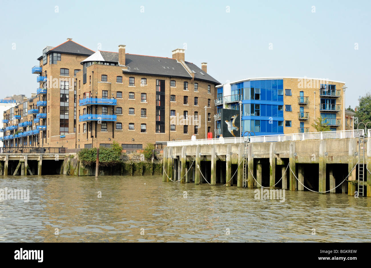 Modern flats with blue balconies overlooking the River Thames at