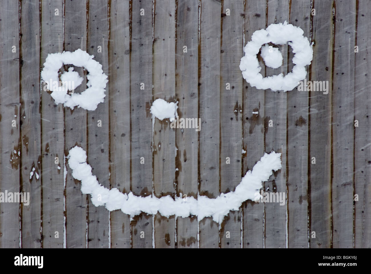Smiley face made out of snowballs Stock Photo
