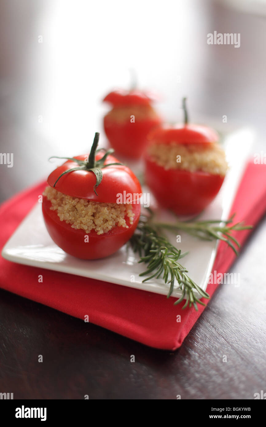 Quinoa stuffed tomatoes with rosemary herb Stock Photo
