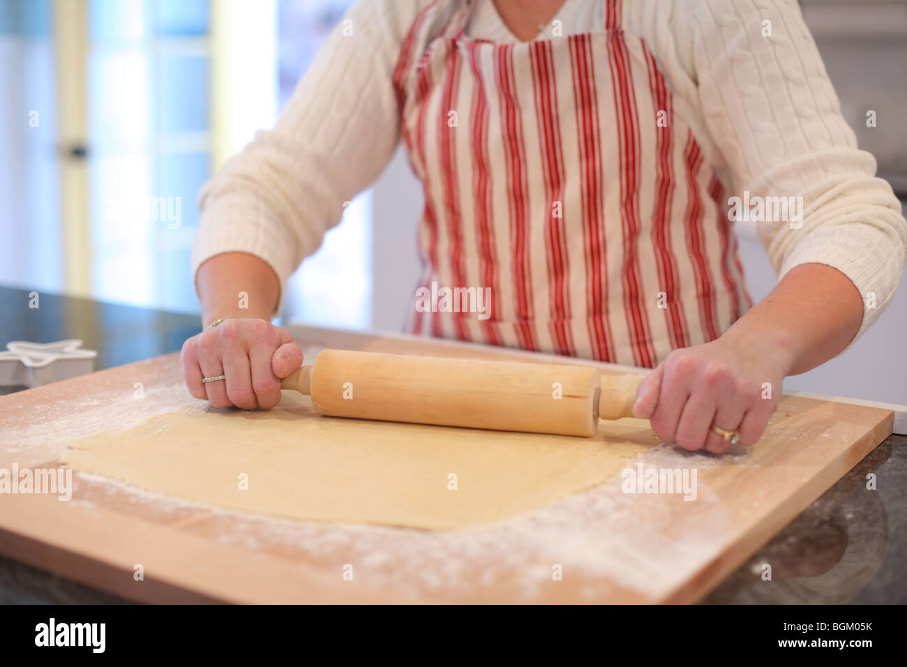 Rolling dough with rolling pin Stock Photo