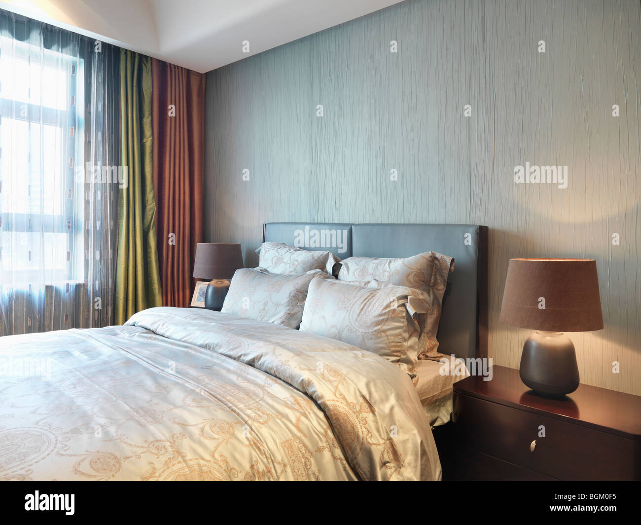 Nightstand and lamps on both sides of bed Stock Photo Alamy