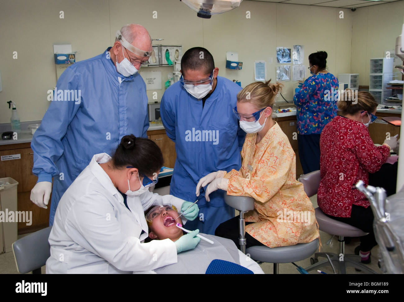 Group of students with their instructor during a dental class patient