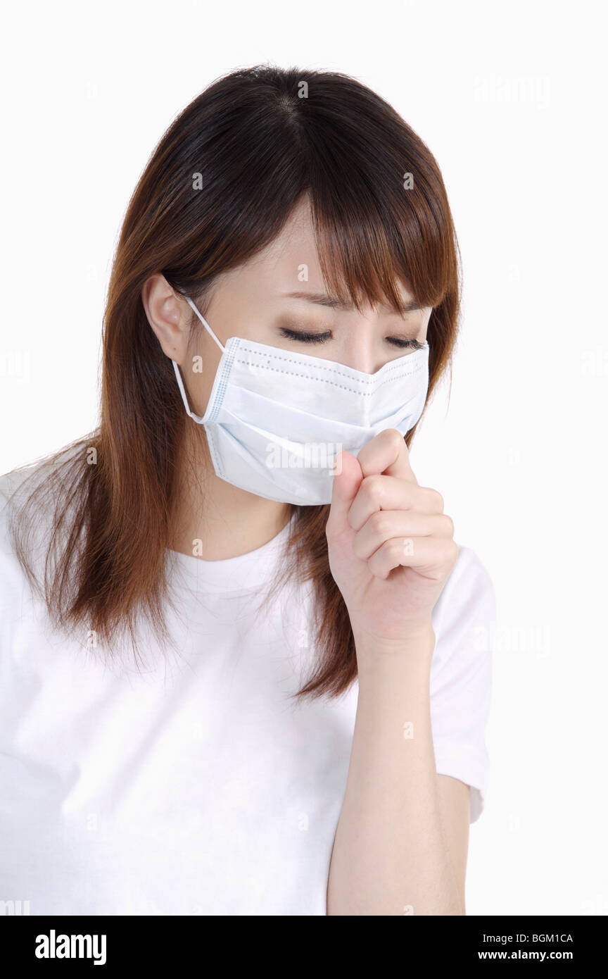 Young woman got a cold, coughing and wearing a surgical mask Stock