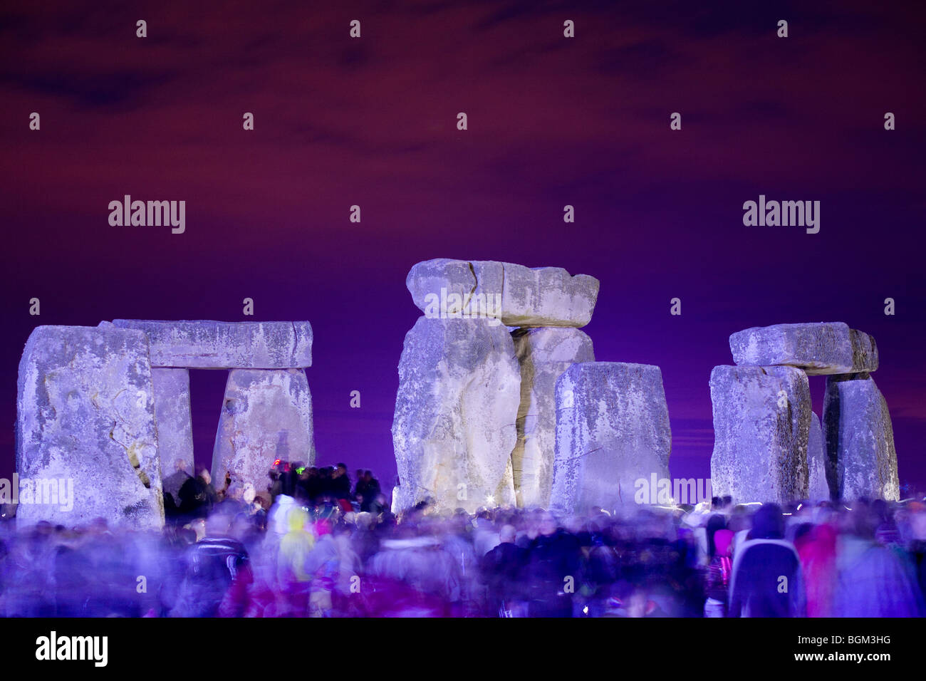 The central standing stones floodlit at night for the summer solstice at Stonehenge. Stock Photo