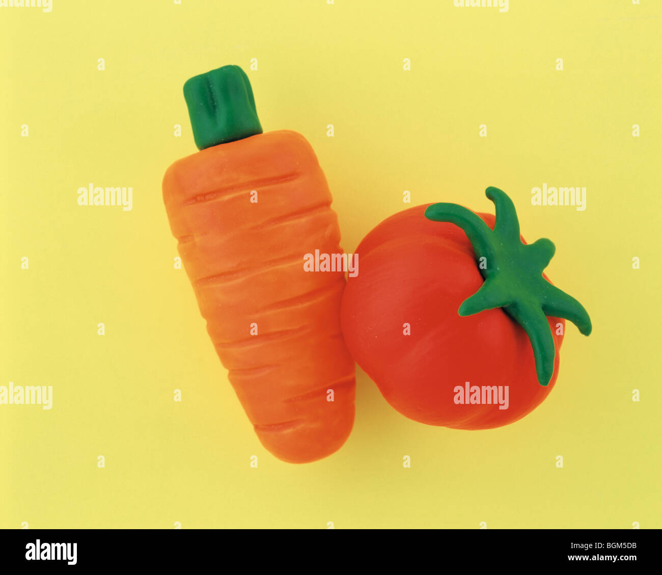 Plasticine carrot and tomato Stock Photo