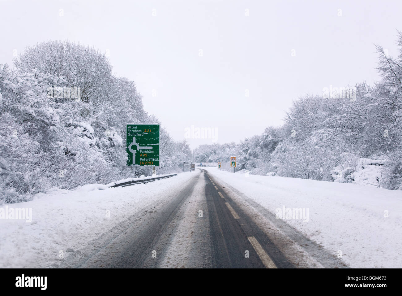 The A31 road at the junction with the A32 roundabout during the snow in