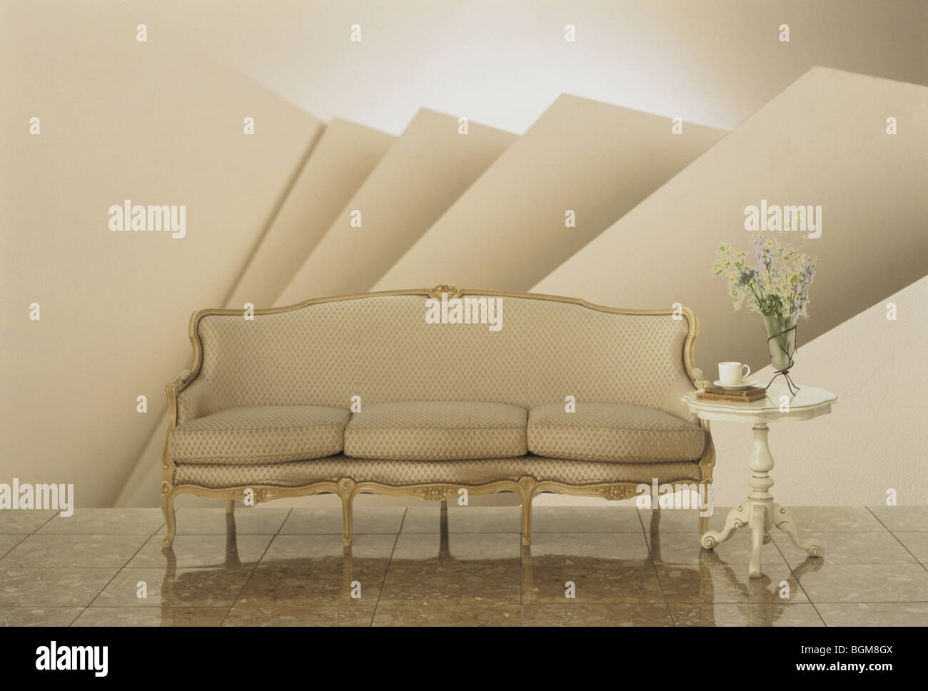 Beige oldfashioned sofa with side table Stock Photo Alamy