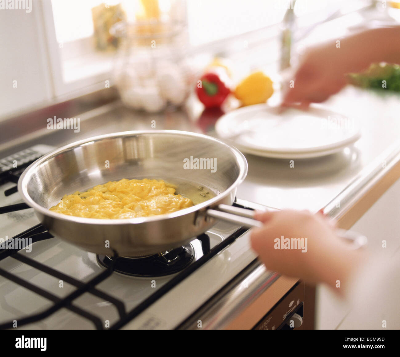 Person cooking scrambled eggs Stock Photo - Alamy