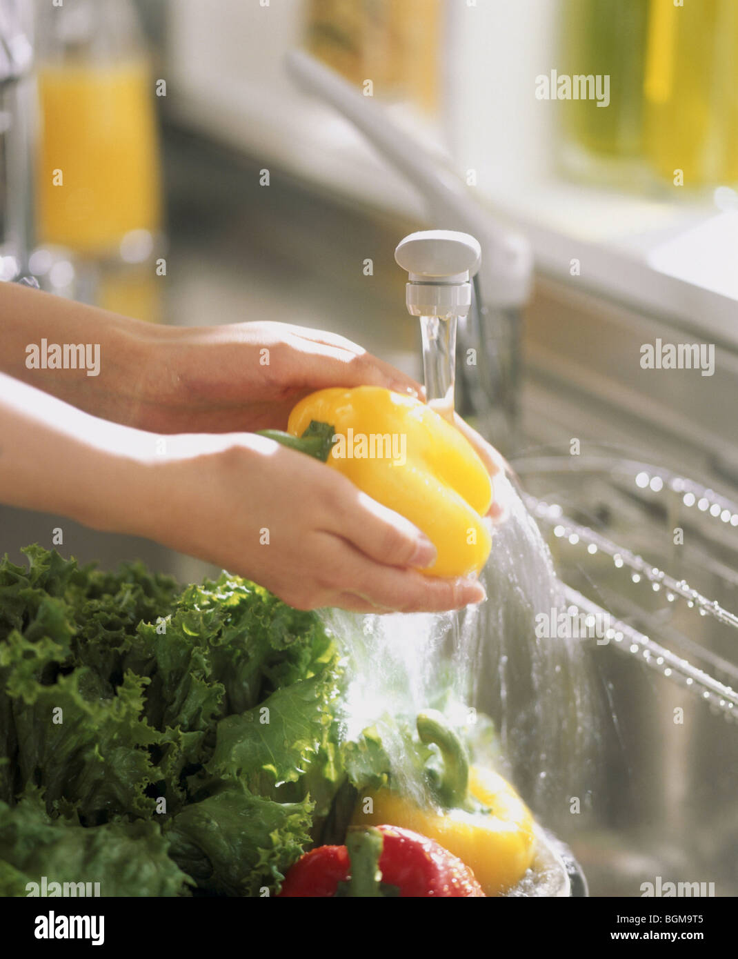 Hands washing yellow capsicum Stock Photo Alamy