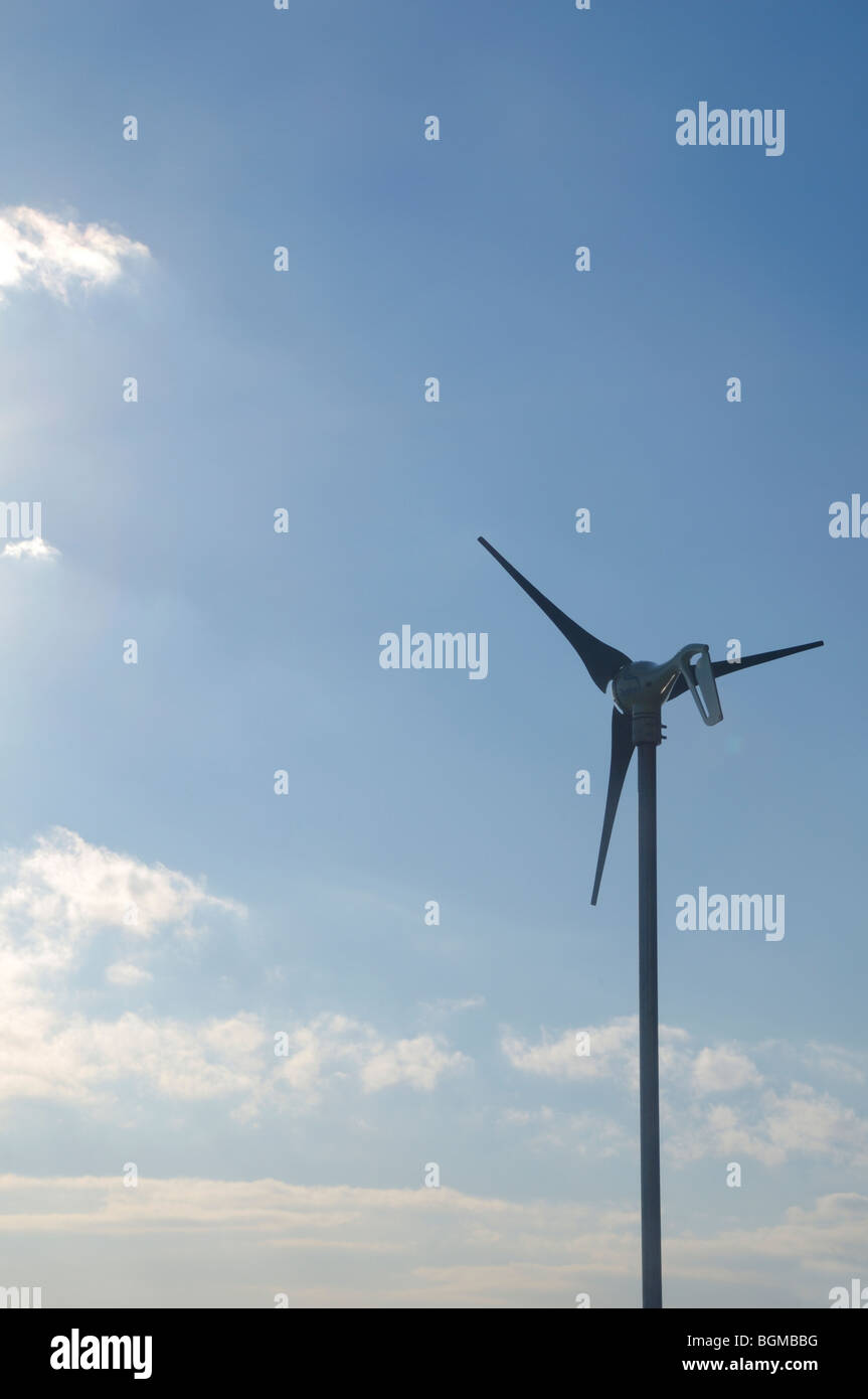 Wind turbine against blue sky with clouds Stock Photo - Alamy