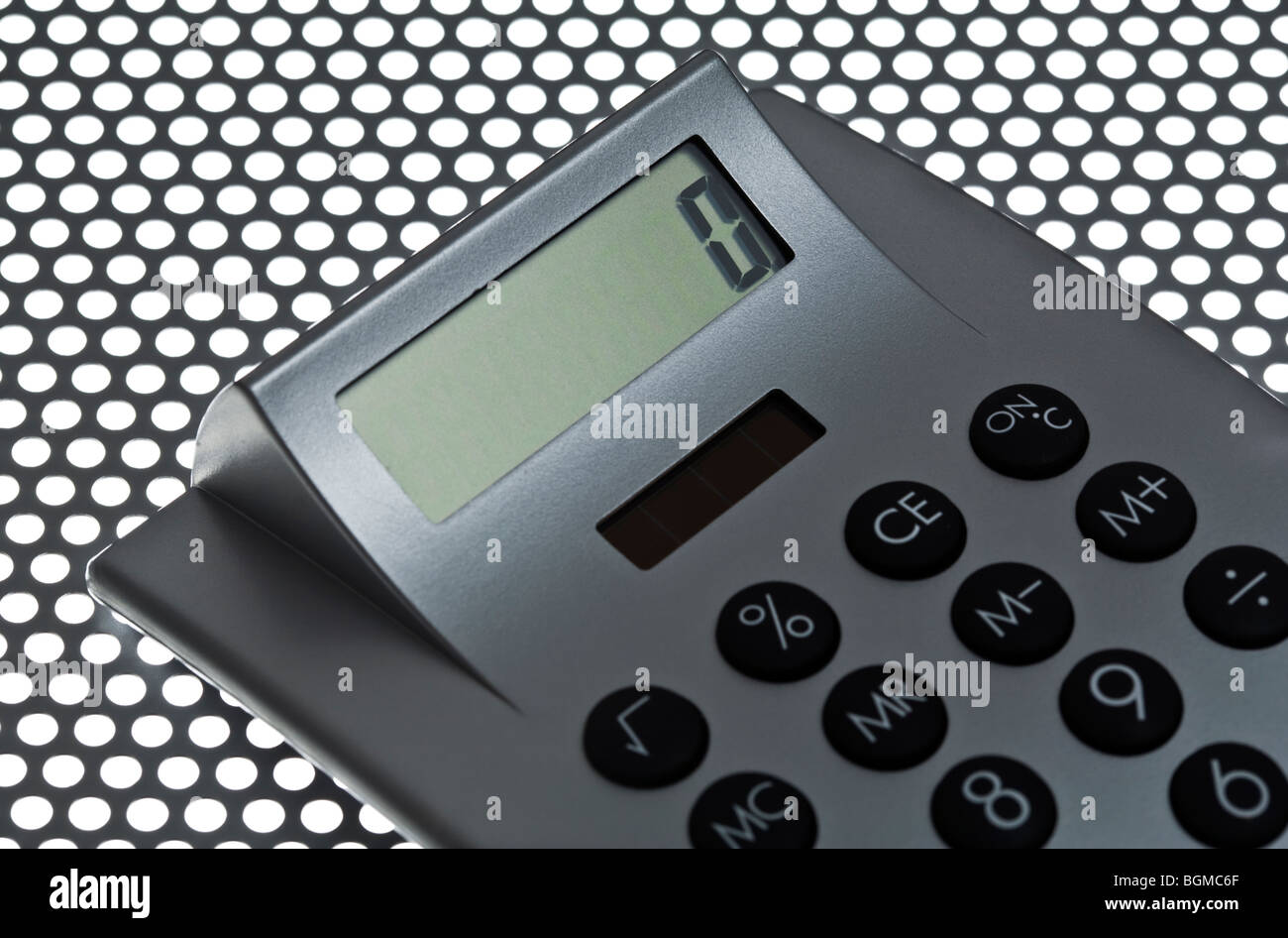 electronic calculator detail on perforated sheet metal Stock Photo