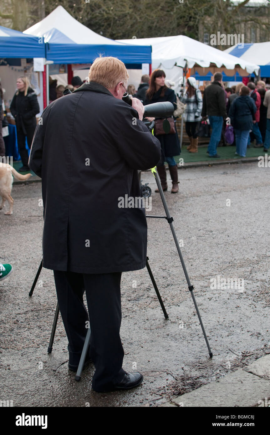 Man looking through a spotting scope at Chatsworth Christmas Market