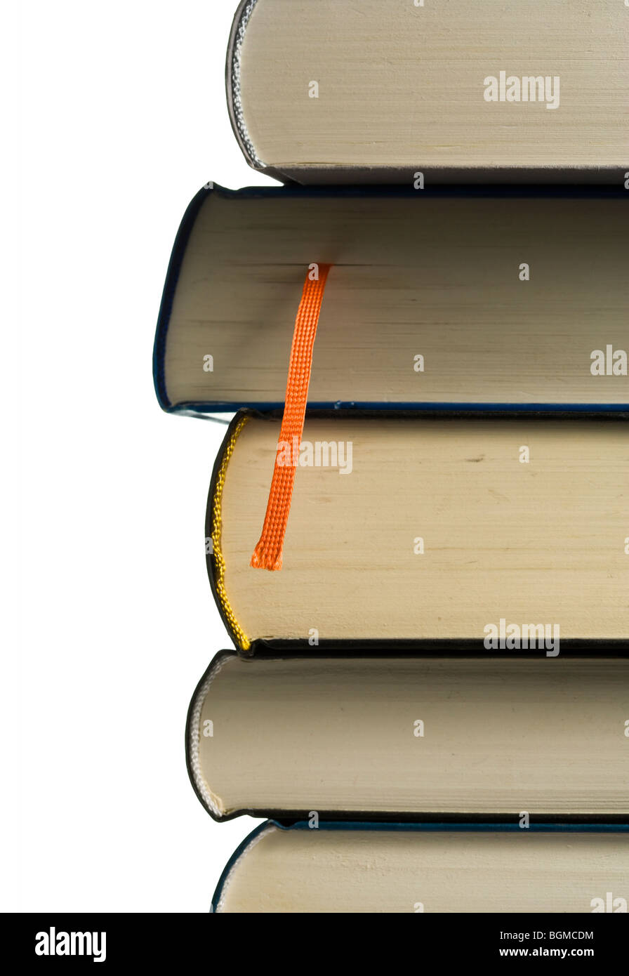 stack of books, closeup, orange bookmark in focus Stock Photo