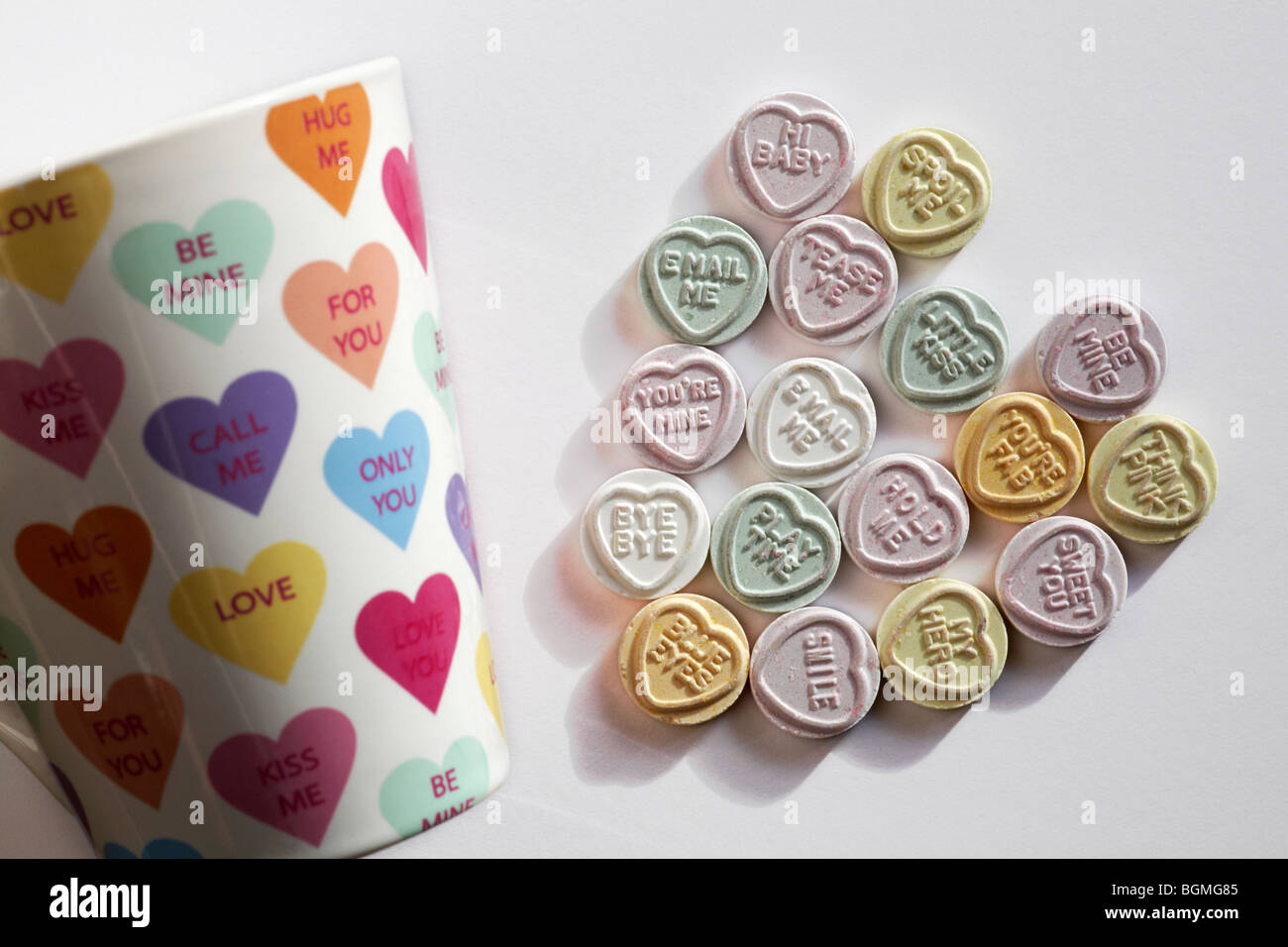 Sweetheart sweet heart - Love heart sweets with messages, arranged in a heart shape together with love hearts mug for Valentines day, Valentine day Stock Photo