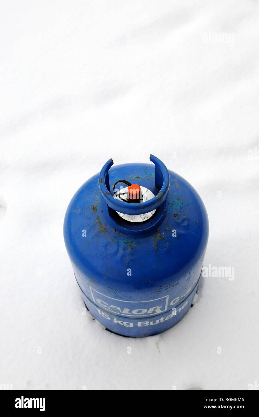 Calor Gas company Butane gas cylinder bottle standing in snow Stock