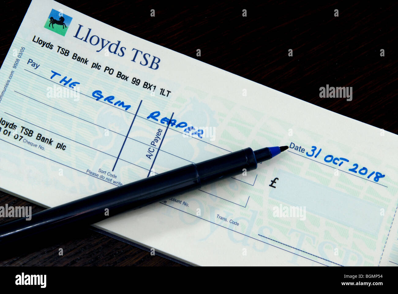 Cheque to the Grim Reaper dated 31 Oct 2018 to illustrate the potential last date for cheques as acceptable form of payment Stock Photo