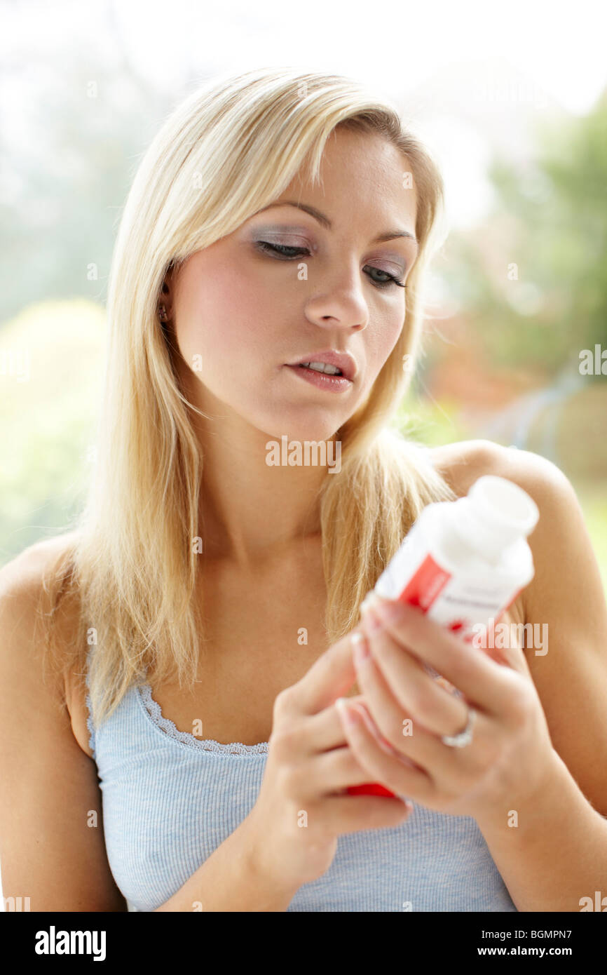 Girl taking vitamin tablets Stock Photo