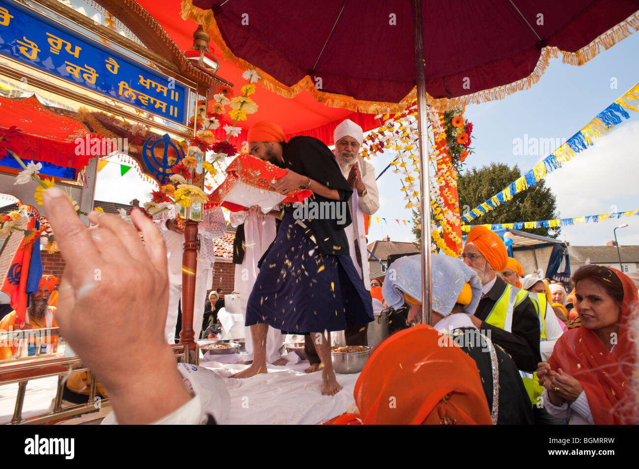 The Guru Granth Sahib is lifted onto a float for the Vaisakhi