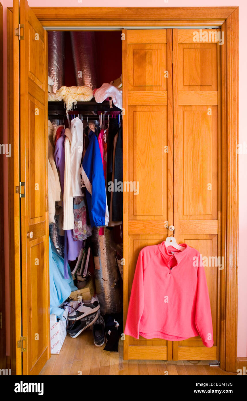 A clothes closet in a teenage girl's bedroom. Stock Photo
