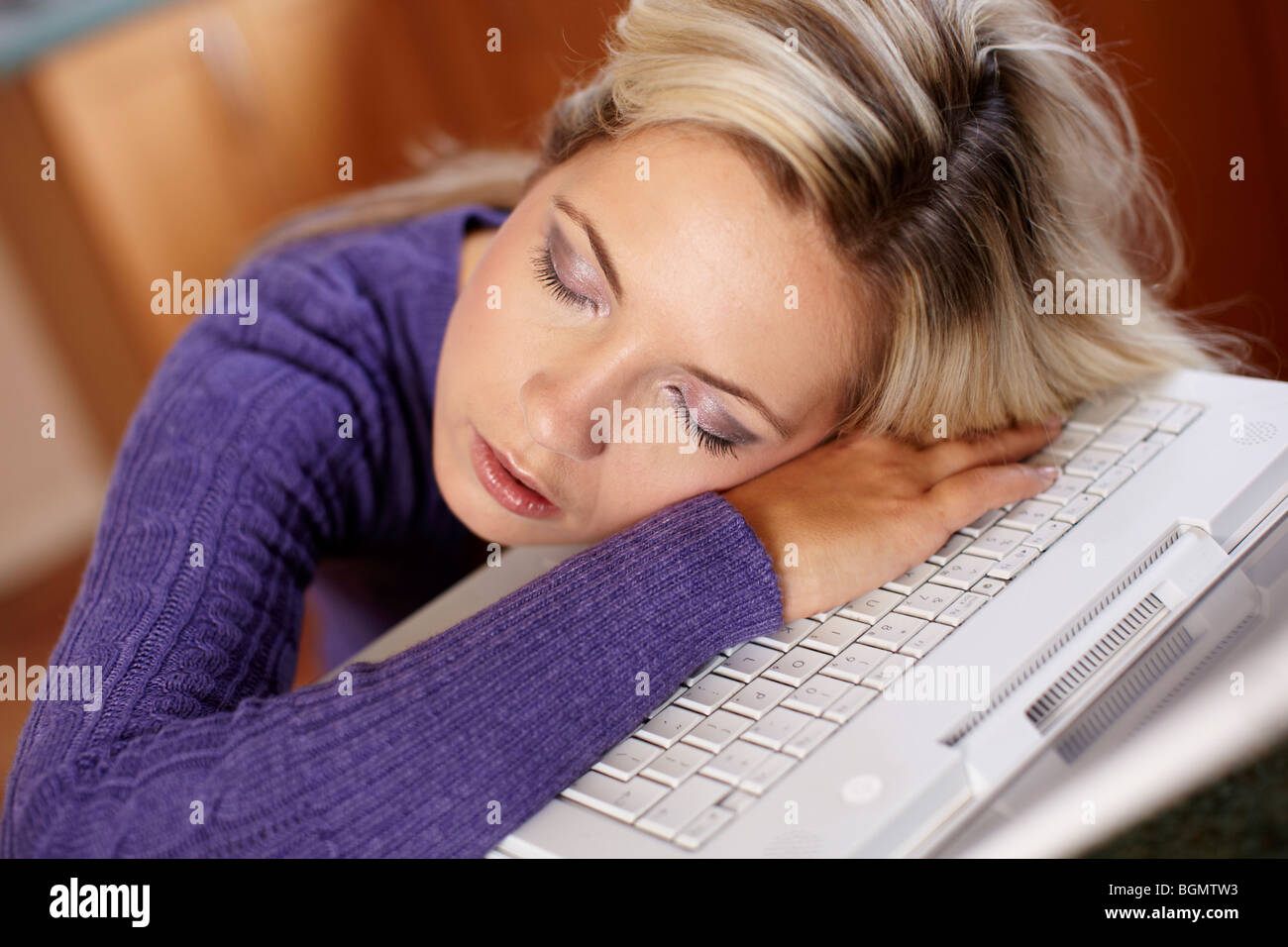 Girl asleep on laptop Stock Photo