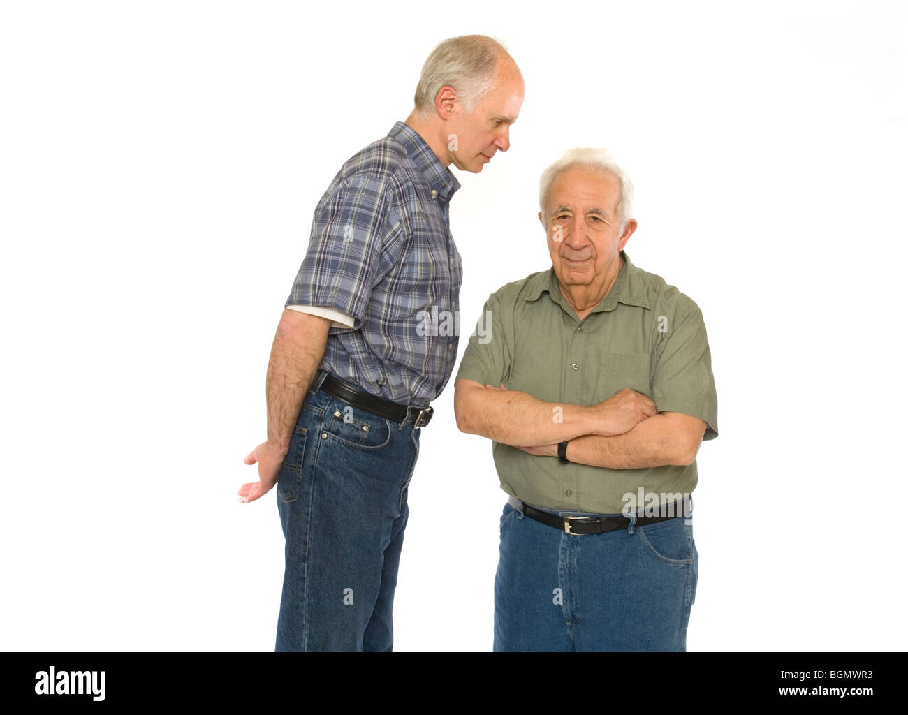 A senior retired elderly gentleman stands with a tall middle aged man. Stock Photo