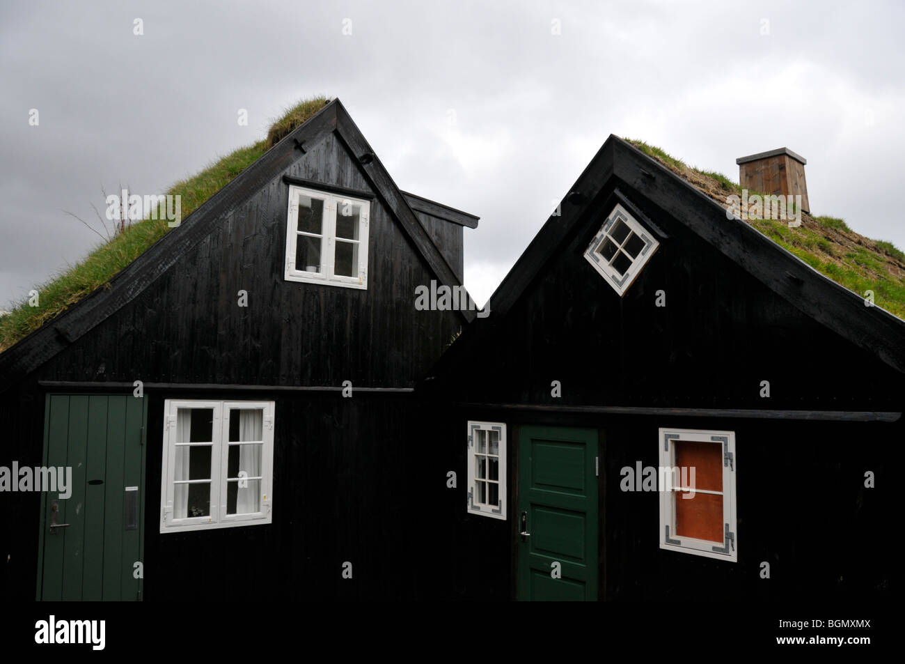 A typical Faroe Islands dwelling, with turf roof a green door and red window Stock Photo