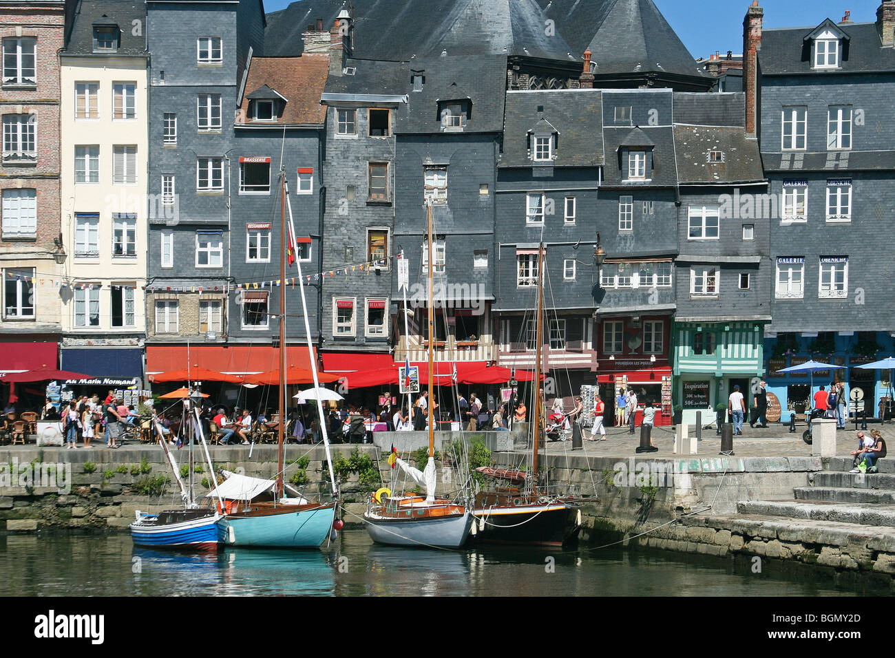 Boats and tourists in the old harbour of Honfleur, Normandy, France