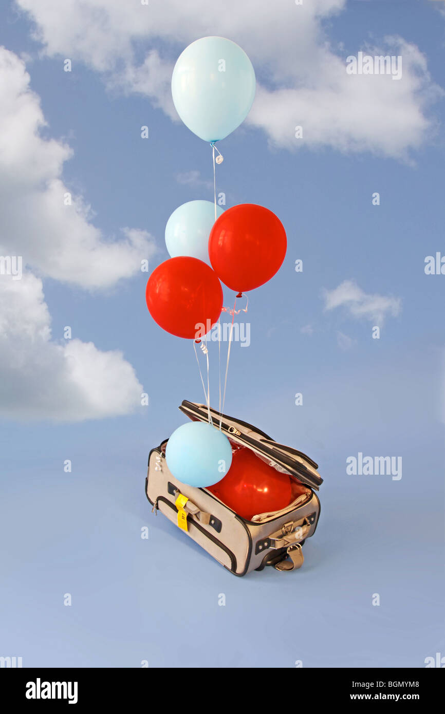 balloons rise from open suitcase Stock Photo