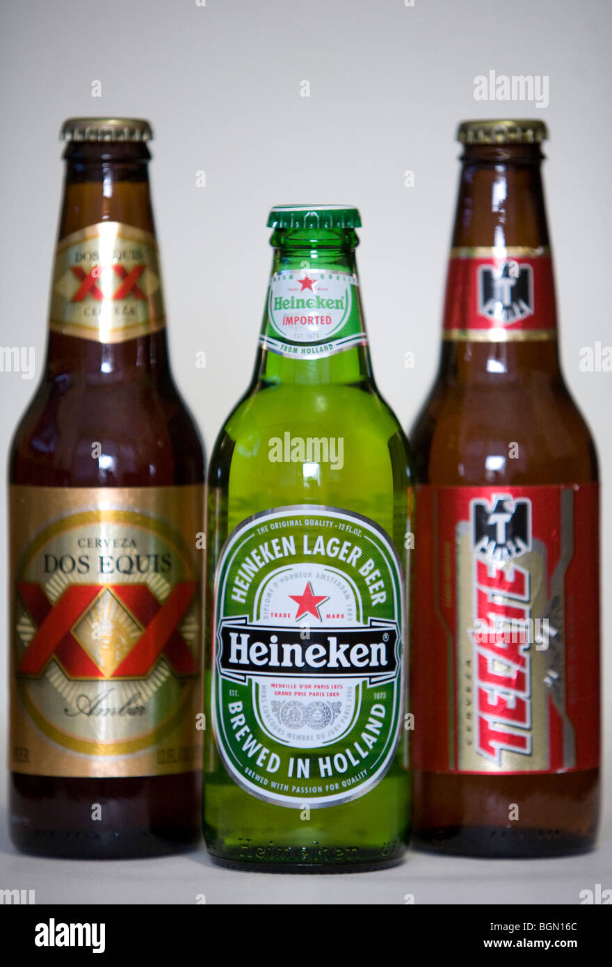 Tecate, Heineken and Dos Equis beer bottles.  Stock Photo
