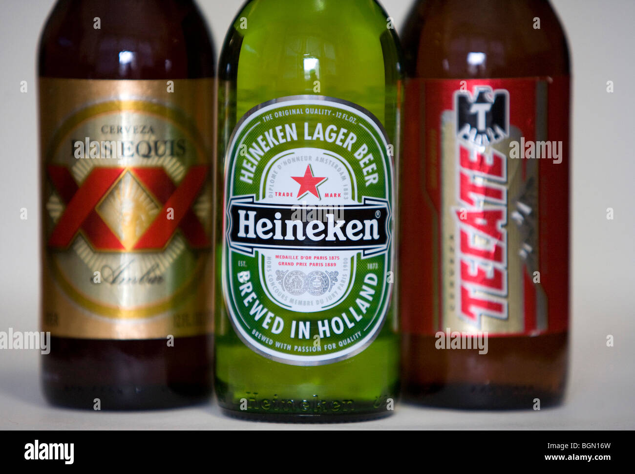 Tecate, Heineken and Dos Equis beer bottles.  Stock Photo