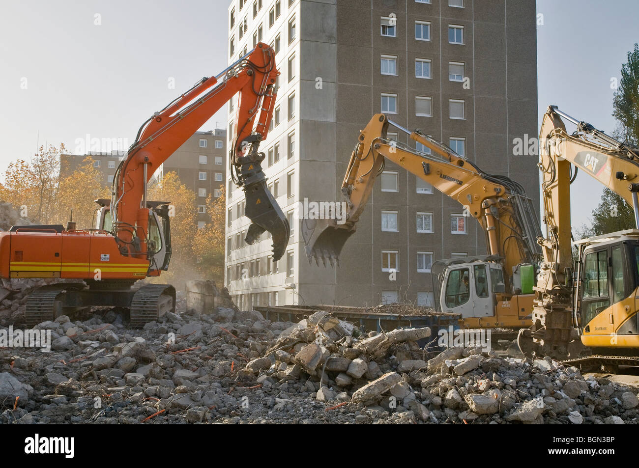 Three excavators in action on a building demolition site of HLM building, France Stock Photo