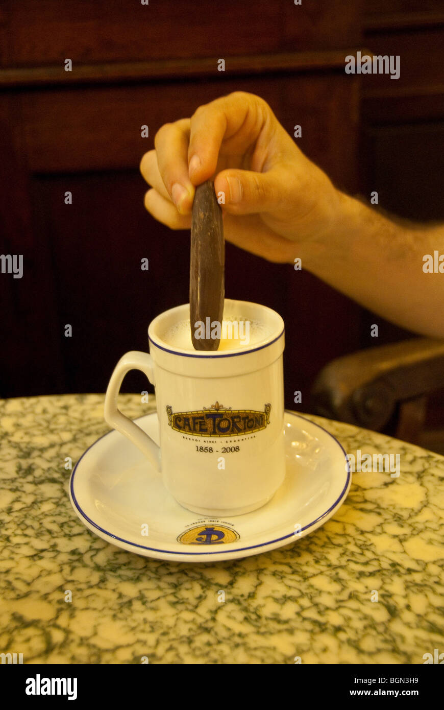 Close-up of person dipping chocolate in hot chocolate at Cafe Tortoni in Buenos Aires, Argentina Stock Photo