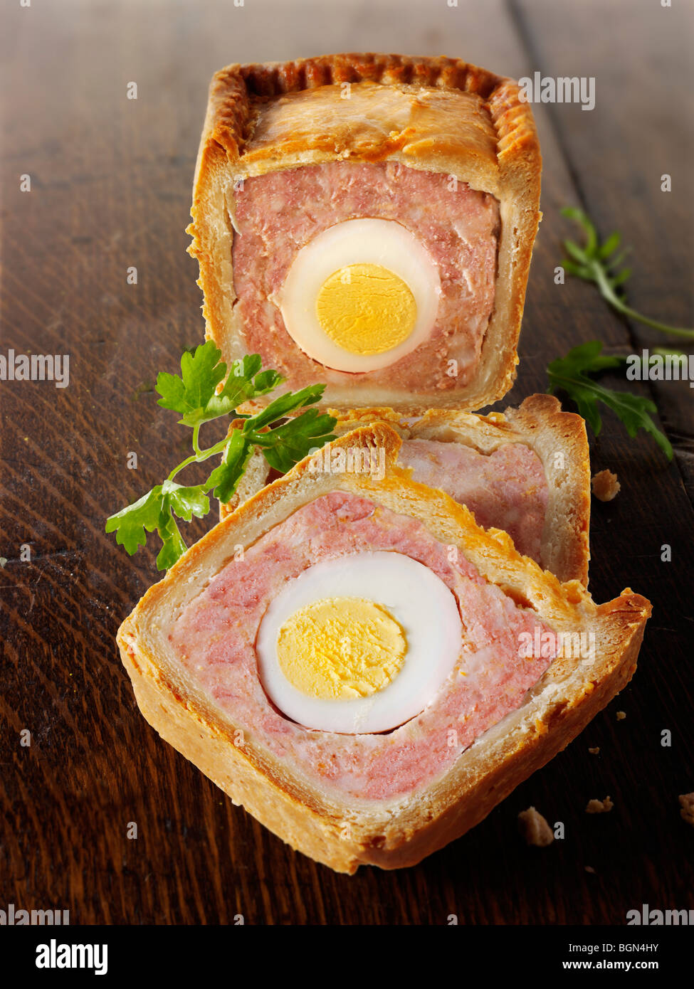 Traditional British pork pastry pie with an egg running through it ready to eat Stock Photo