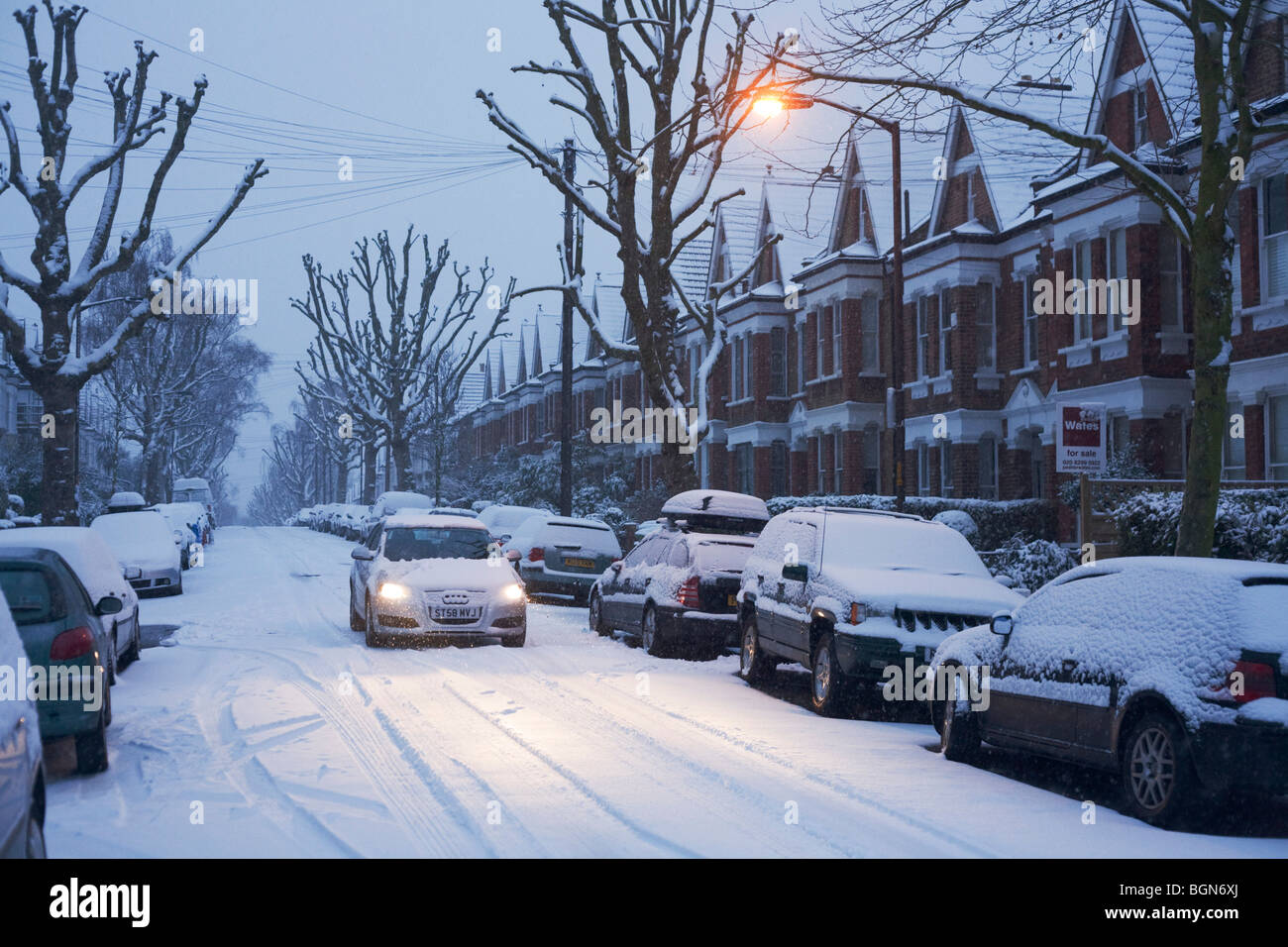 A still and snowbound residential street in Dulwich, South London, the morning after yet another overnight bad weather. Stock Photo