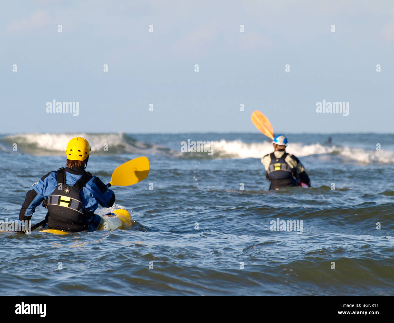 Two sea kayakers heading out, Cornwall. Stock Photo