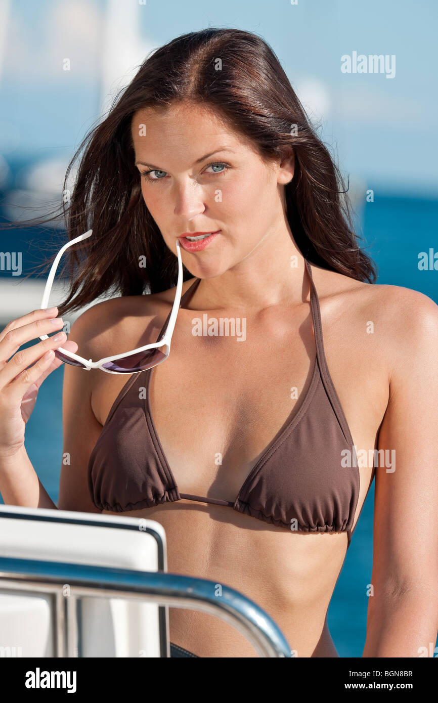 Young woman sailing on luxury yacht sunbathing in bikini Stock ...