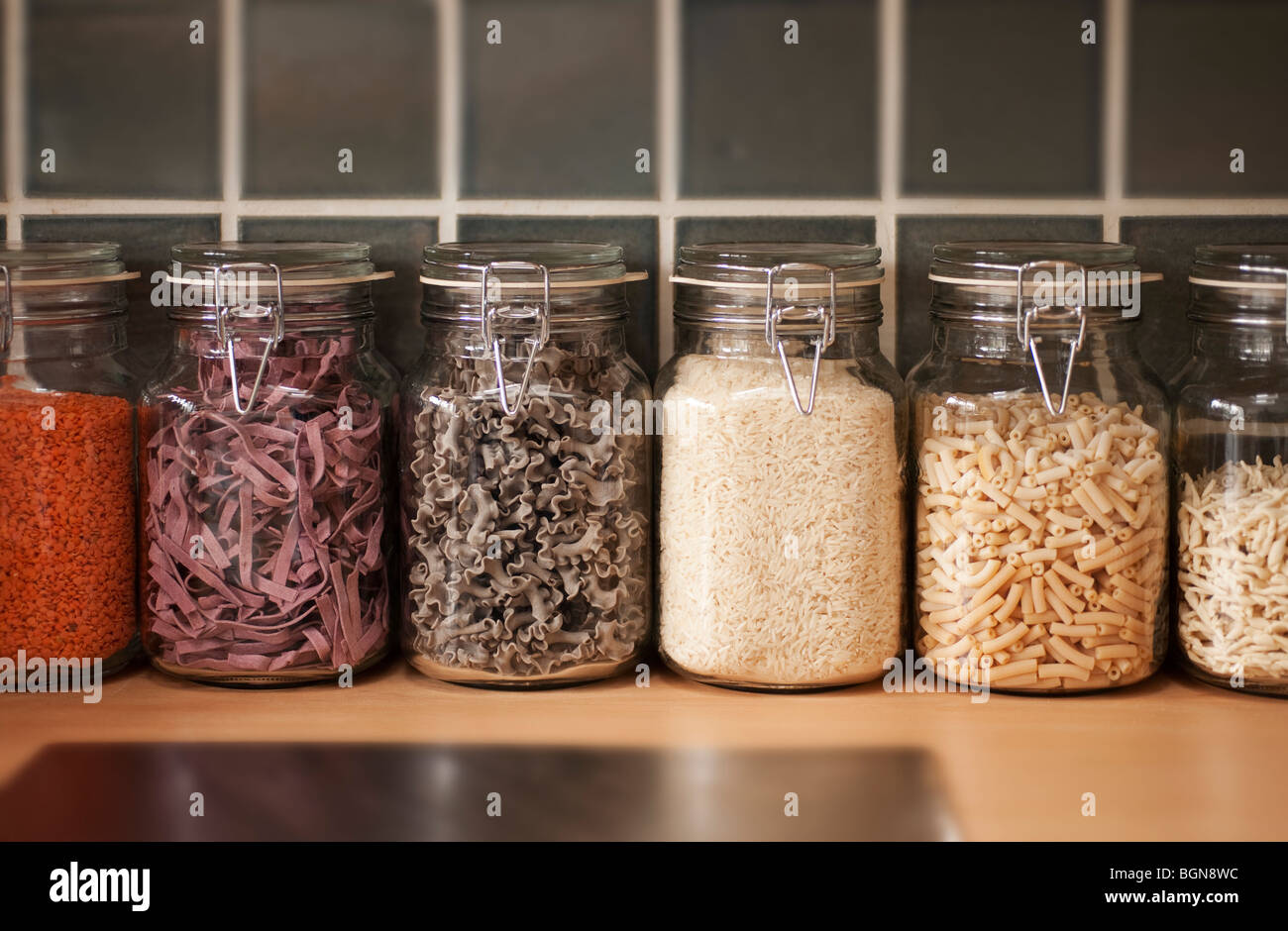 Row of ood storage jars in kitchen filled with dried ingredients Stock ...