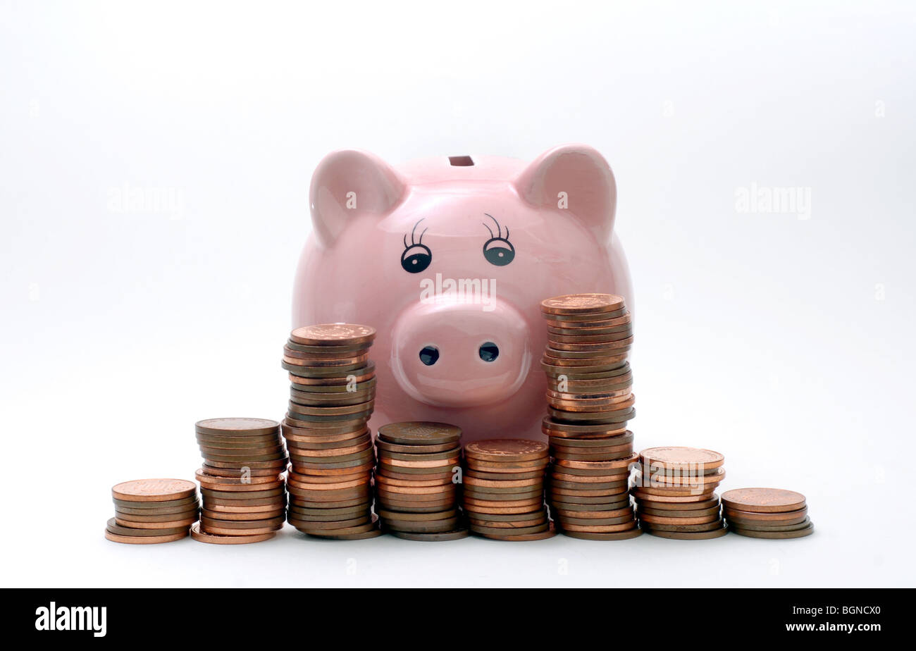 PIGGY BANK WITH BRITISH COINS RE SAVINGS THE ECONOMY MONEY WAGES INCOMES THE RECESSION CASH MONEY MORTGAGES BANKS INFLATION UK Stock Photo