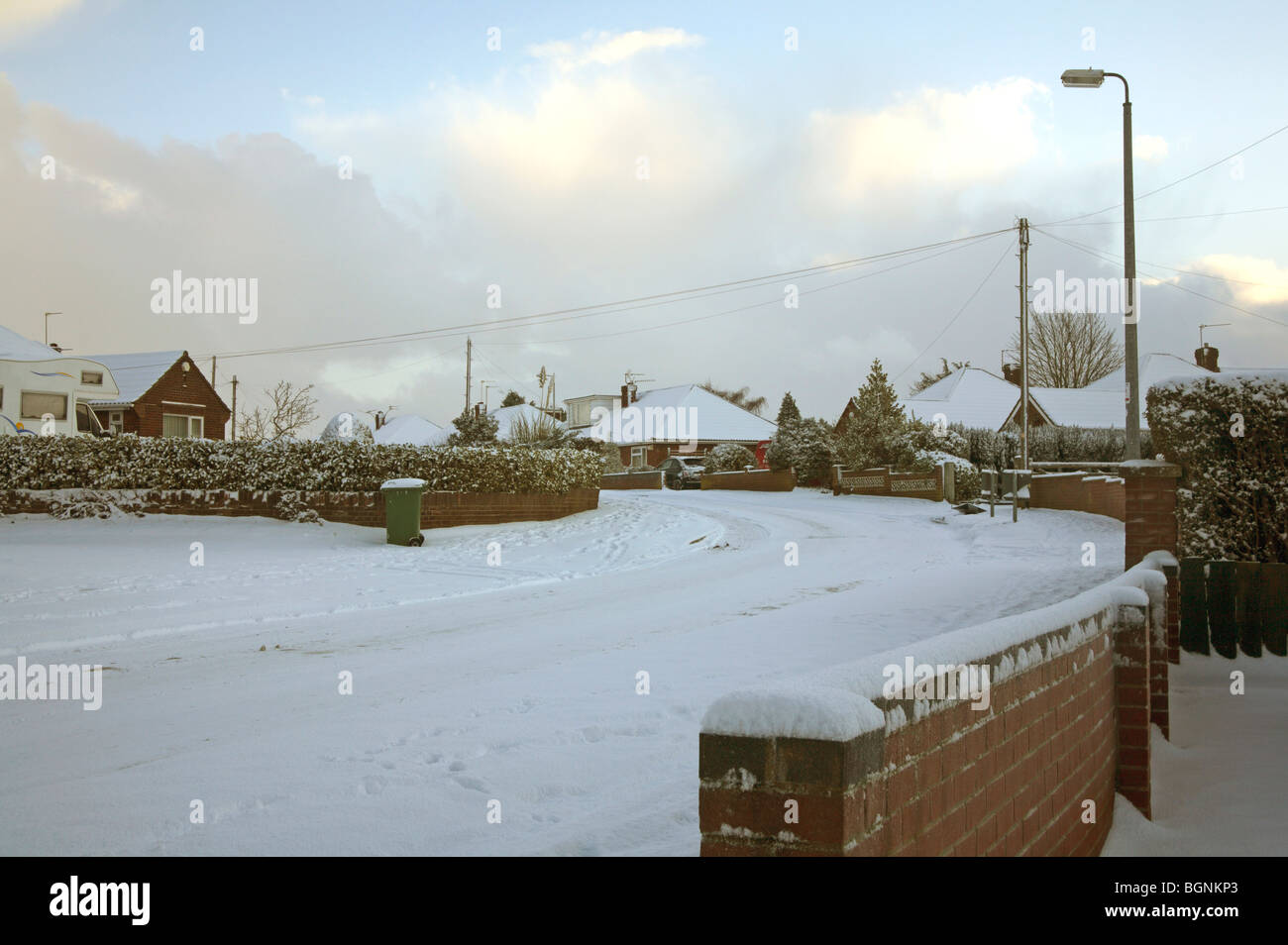 Untreated urban road after moderate snowfall at Hellesdon, Norfolk