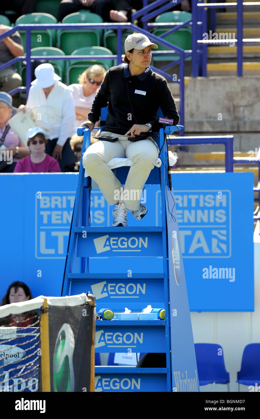 Female tennis umpire watches a match during the Aegon International