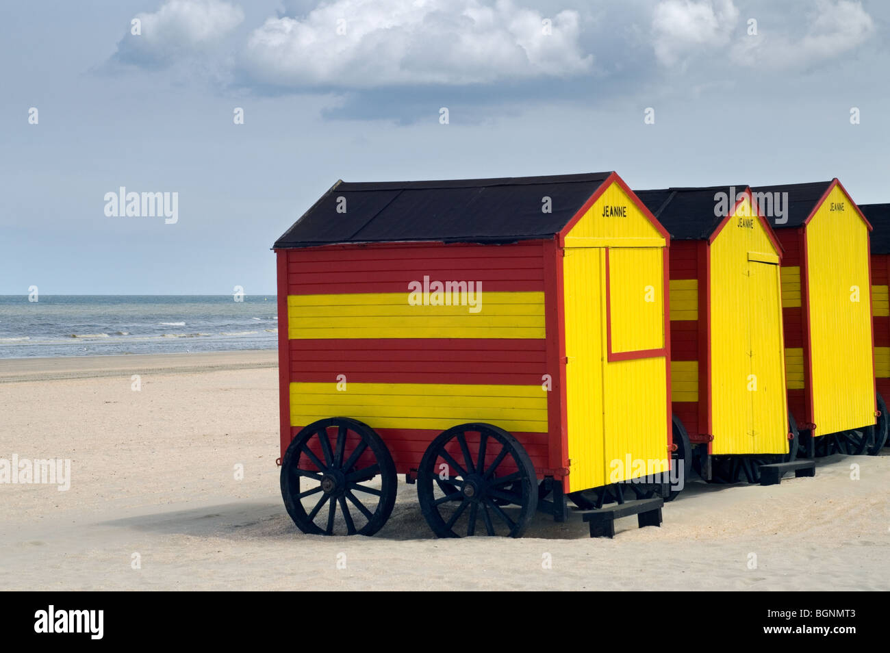 Row Of Colourful Striped Beach Cabins On Wheels Along The North