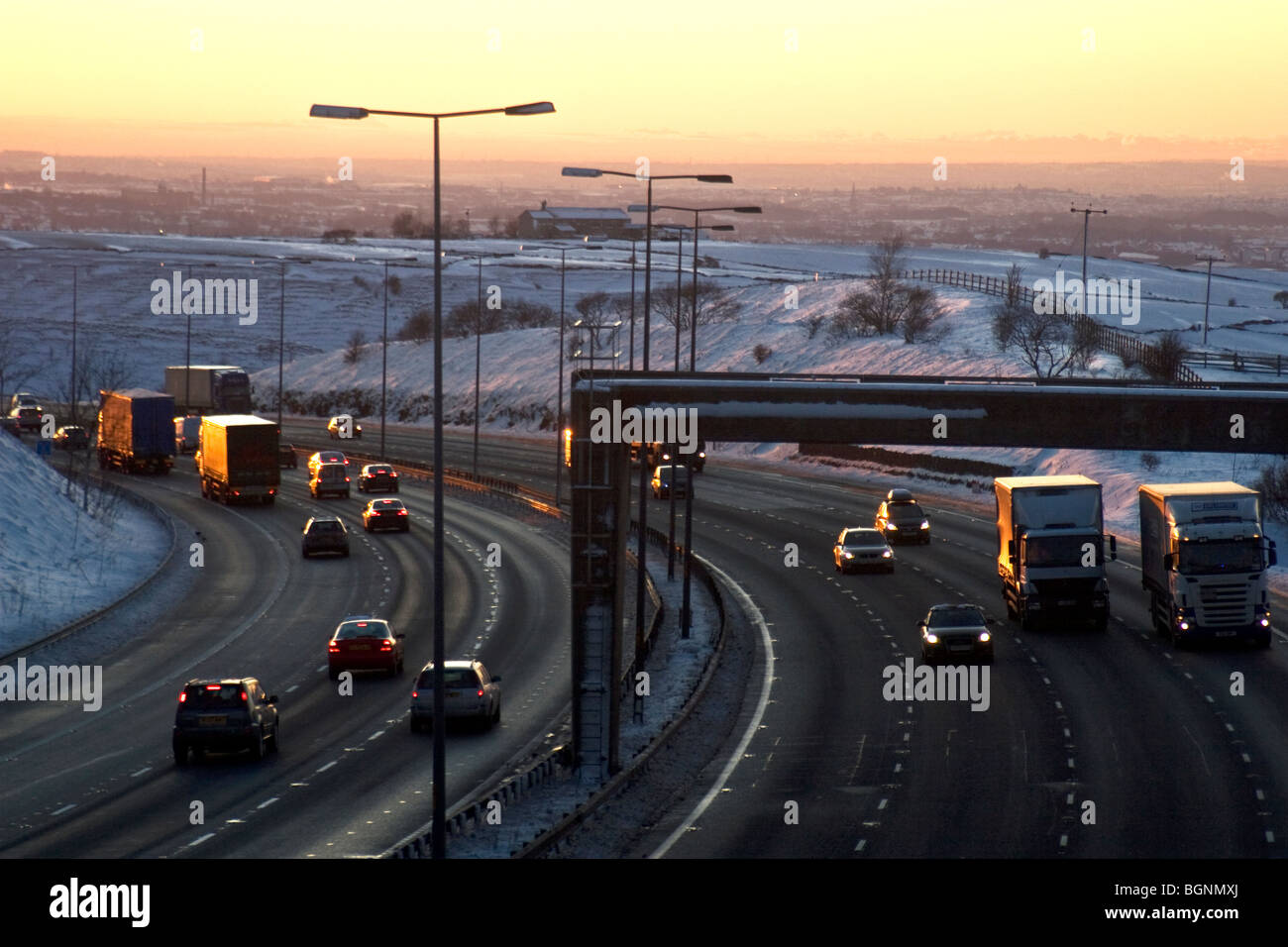 M62 motorway at dusk in winter. Near Rochdale, coming down off the Pennines, looking towards Manchester. UK Stock Photo