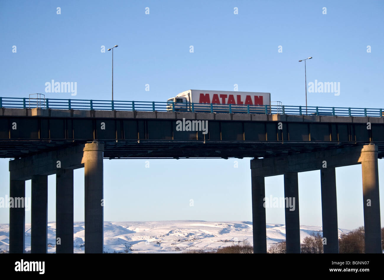 Truck coming down from Pennines on  M62 motorway viaduct near Rochdale,  UK. Hollingworth Lake, Littleborough beyond. Stock Photo