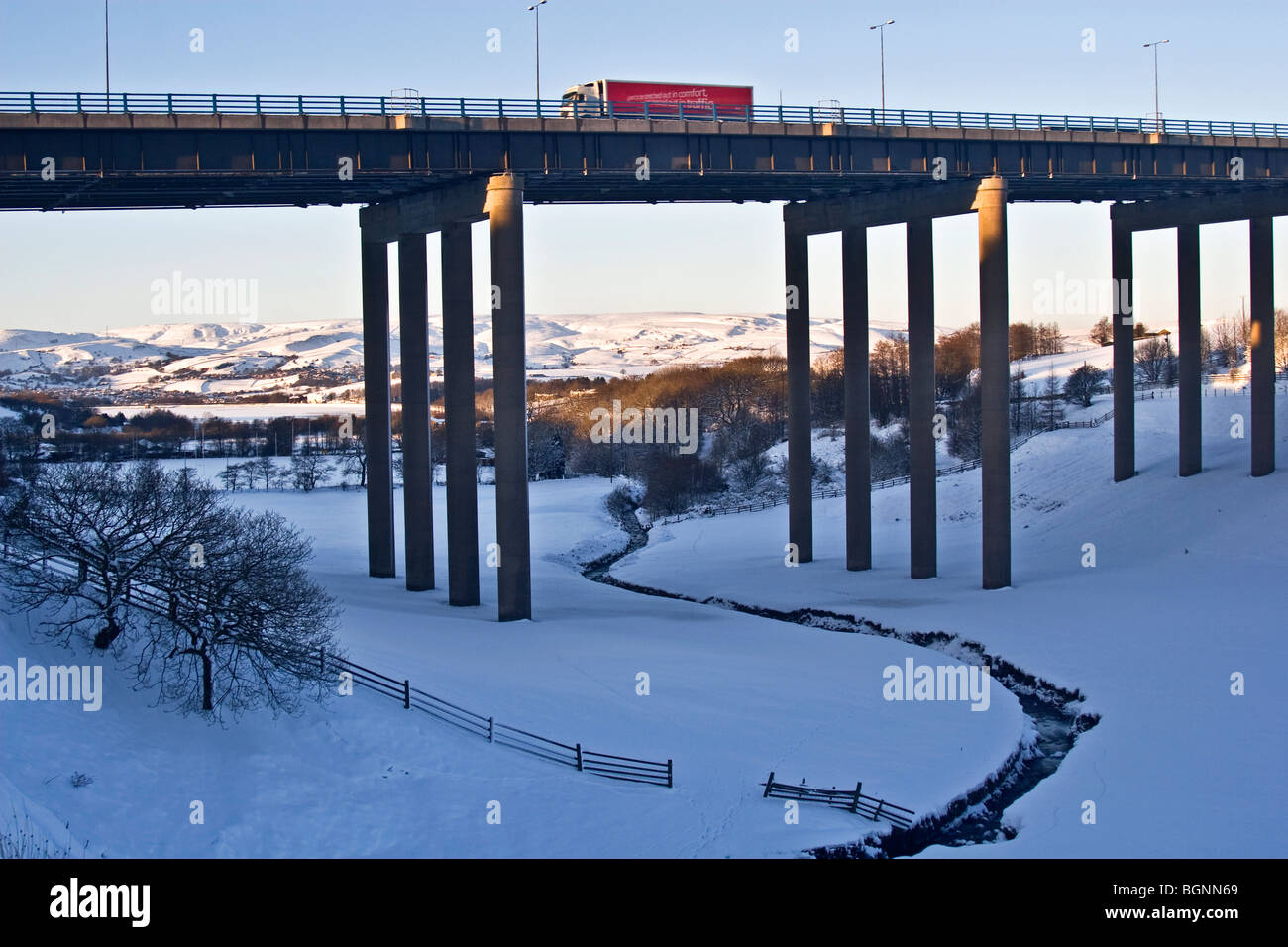 Truck coming down from Pennines on  M62 motorway viaduct near Rochdale,  UK. Hollingworth Lake, Littleborough beyond. Stock Photo