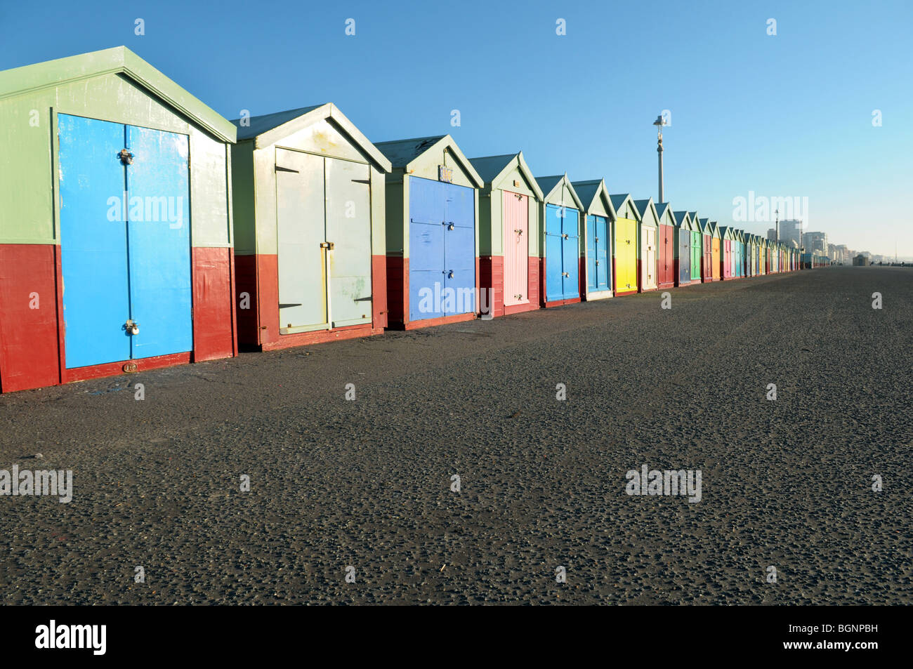 Colourful painted beach huts on the seafront at Brighton and Hove. Stock Photo