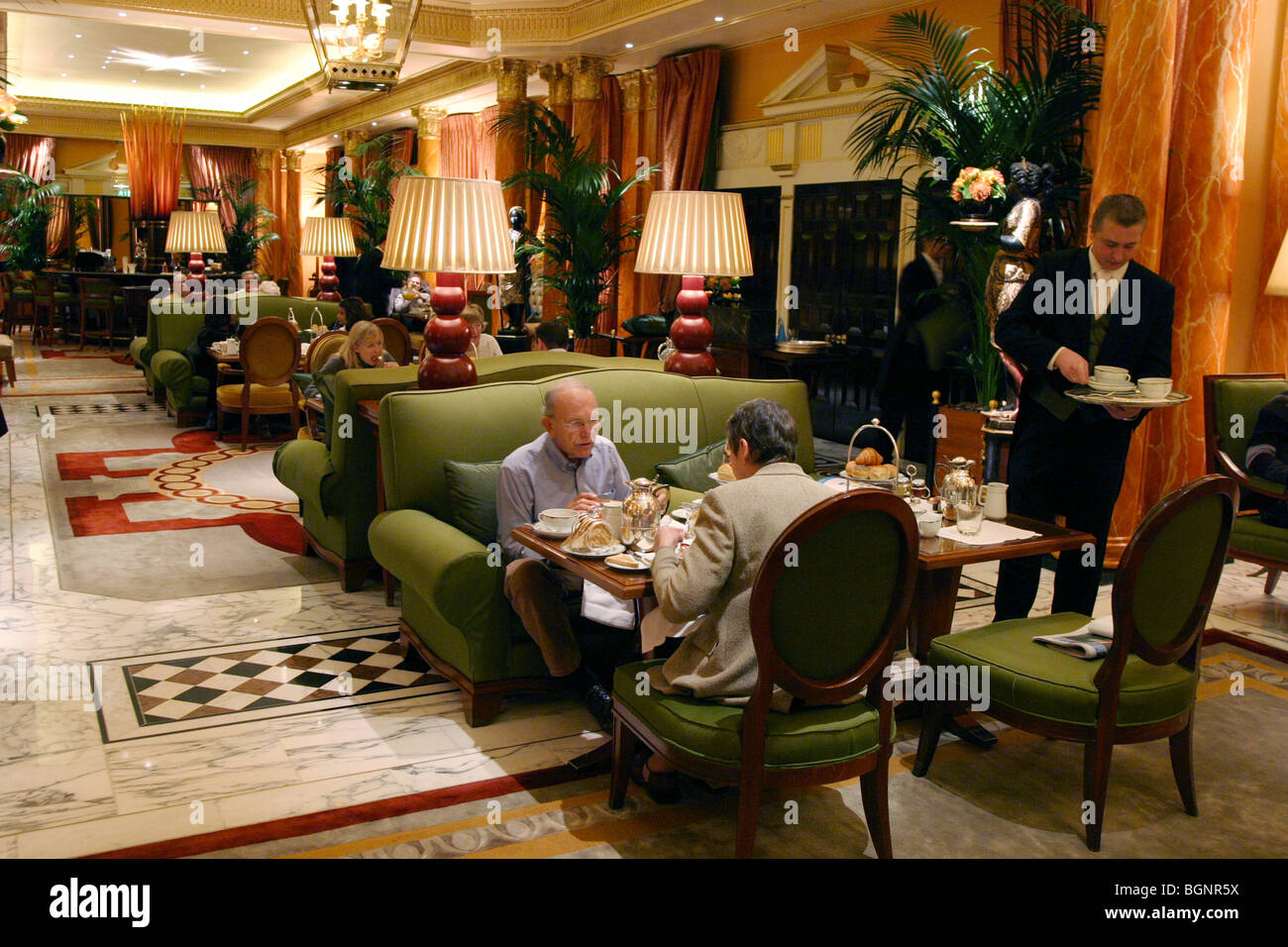 The Dorchester Hotel London interior; A waiter serving breakfast to hotel guests at the Dorchester Hotel, Park Lane, London UK Stock Photo