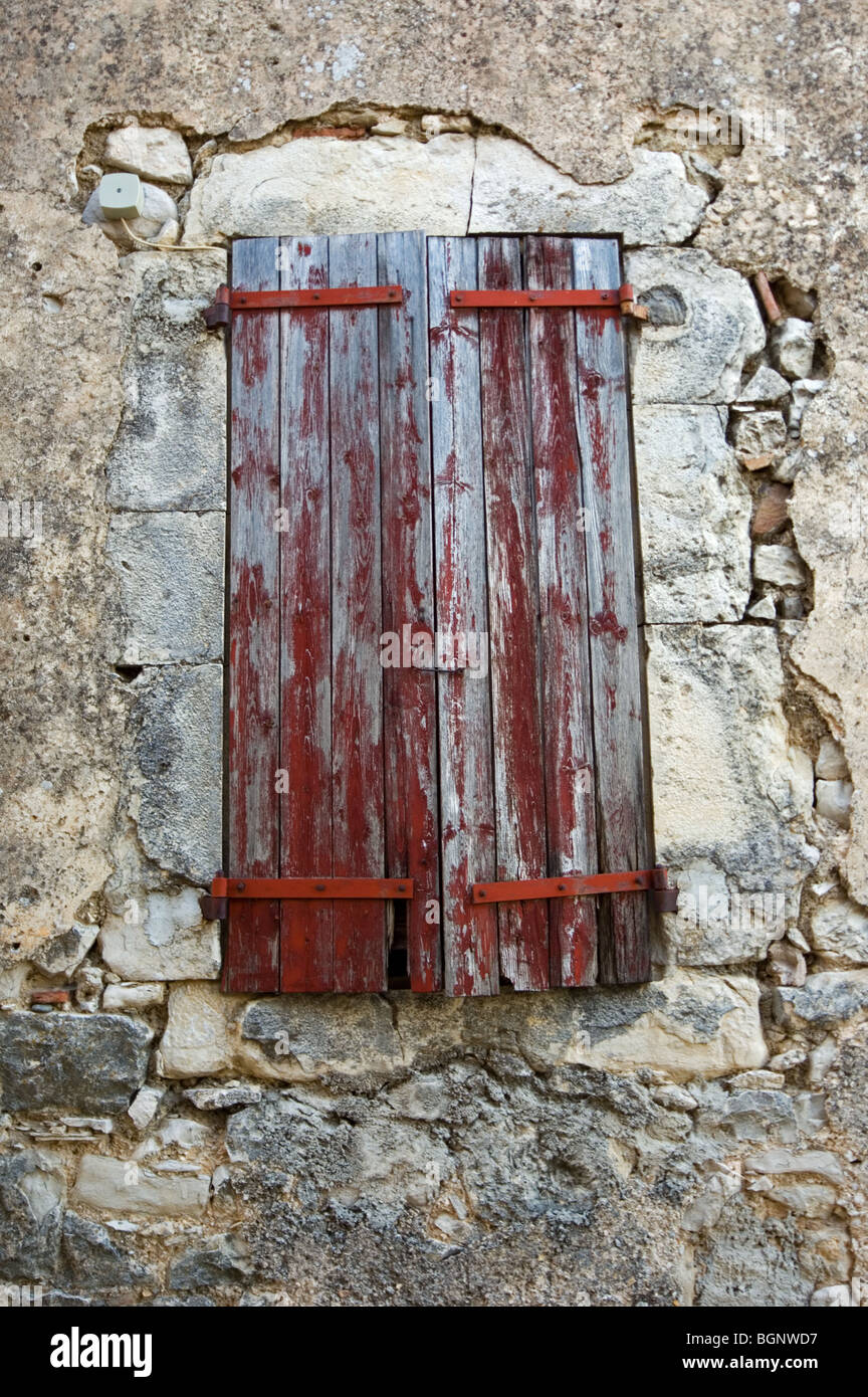 Old red wooden sunblinds / window shutters of traditional house, Banon, Alpes-de-Haute-Provence, Provence, France Stock Photo