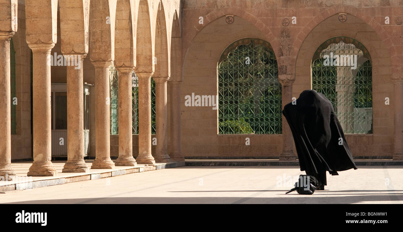 A woman wearing a burka  walks through the Dergah complex of Mosques, Urfa, Turkey Stock Photo